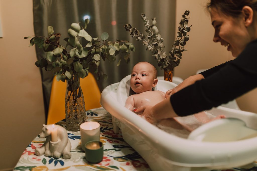 a woman bathing her baby