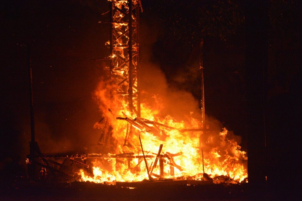 burning wood tower during night time