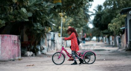 kids riding a tricycle