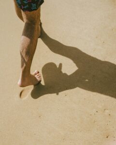 a person walking on brown sand