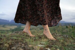 close up photo of a woman s feet with an anklet