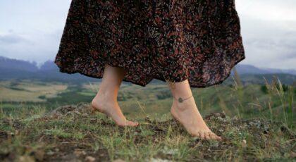 close up photo of a woman s feet with an anklet