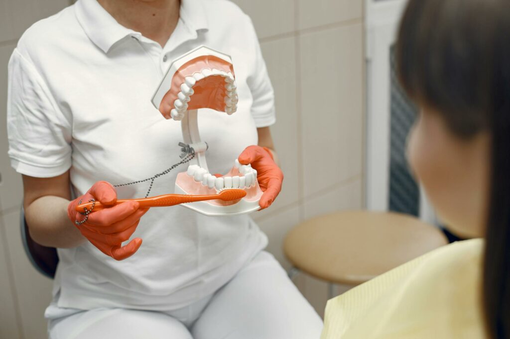 a person holding a dental model