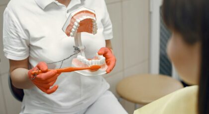 a person holding a dental model